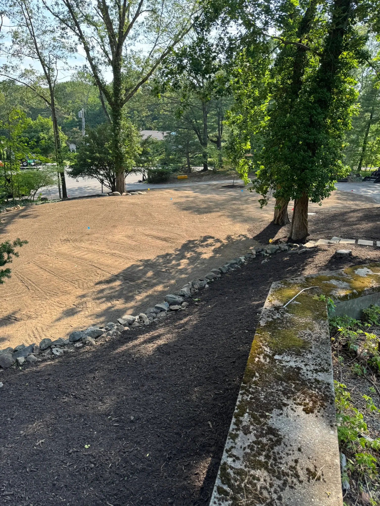 A regraded gravel driveway with a new stone border edge on a Concord, MA property